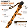 Close-up of the handcrafted black and orange paracord bullwhip handle featuring monkey fist knot, wrist strap, and hanging loop.