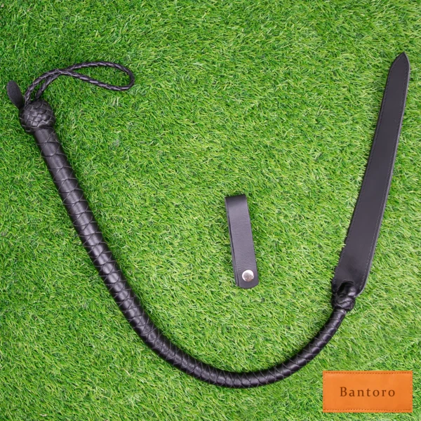 bdsm dragon tail whip black leather full length flat lay