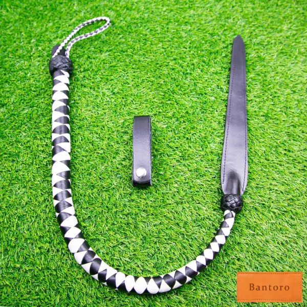 bdsm dragon tail whip black white leather full length flat lay
