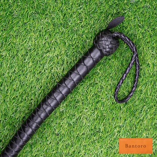 bdsm dragon tail whip black leather handle wrist loop close up