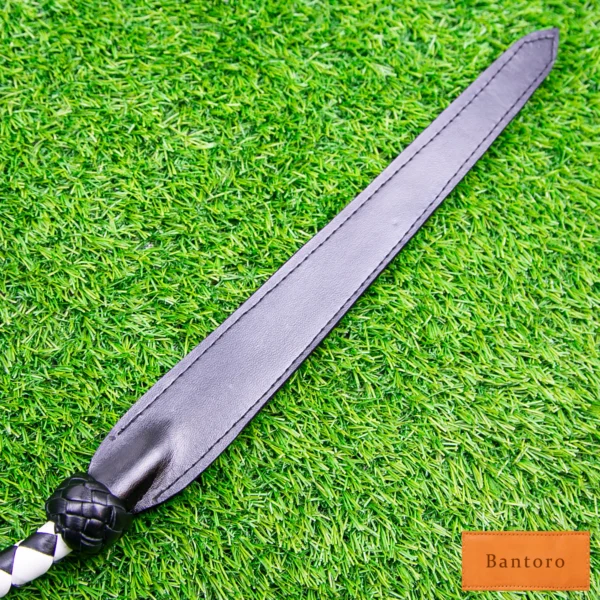 bdsm dragon tail whip black & white leather slapper tip close up