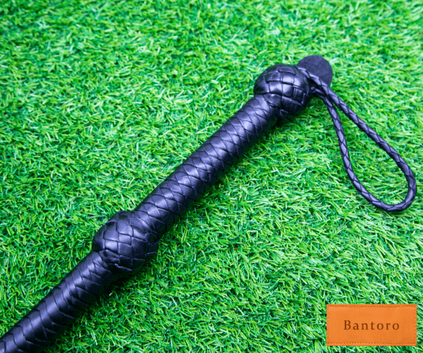 leather flogger black braided handle close up grip detail