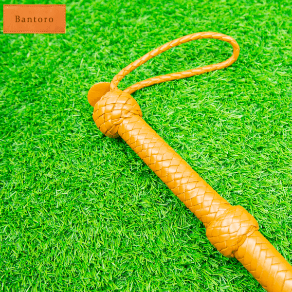 leather flogger tan braided handle grip close up
