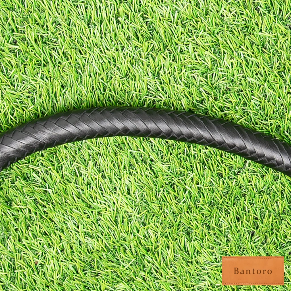 Close-up detail of braided leather bullwhip handle