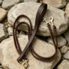 Double dog leash in full-grain brown leather with long handle, twin leads and brass clips